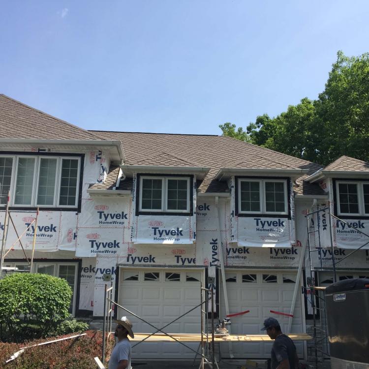 Exterior view of a house, highlighting the stone and siding repair of the home's exterior