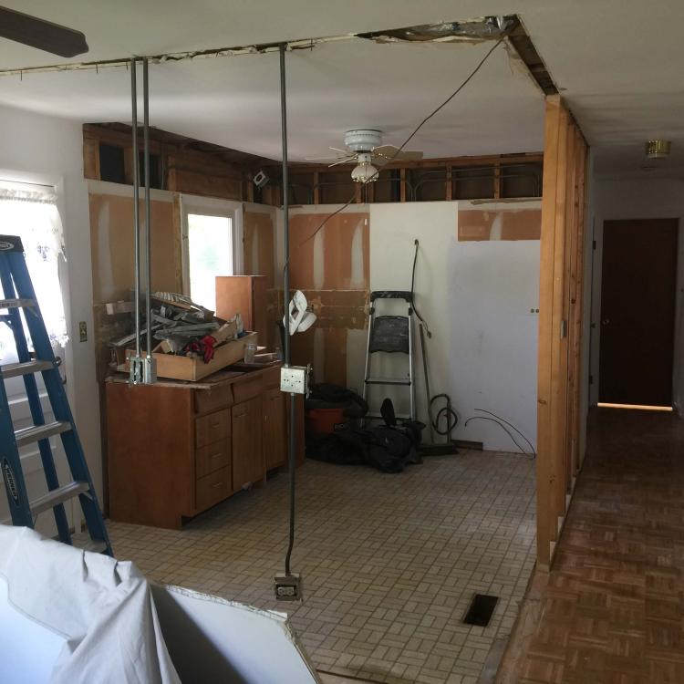 Kitchen renovation in progress: walls removed, exposed wiring