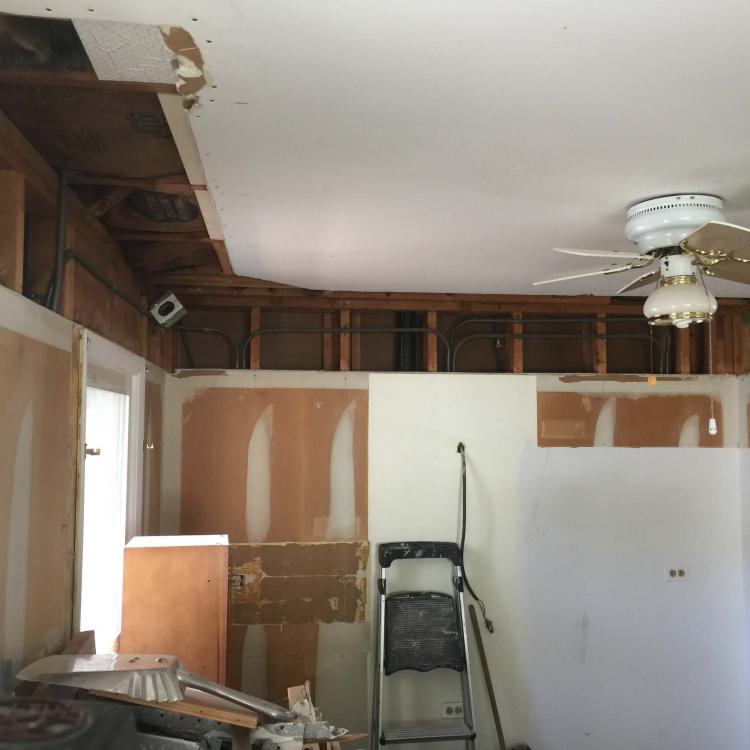 Kitchen renovation in progress: damaged ceiling and exposed framing