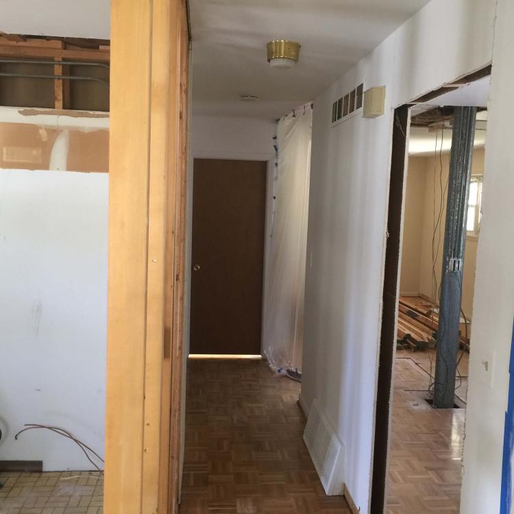 Ongoing home renovation: open doorway and exposed framing