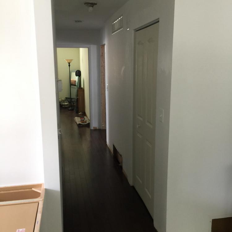 Entering a room through a newly framed and installed door.