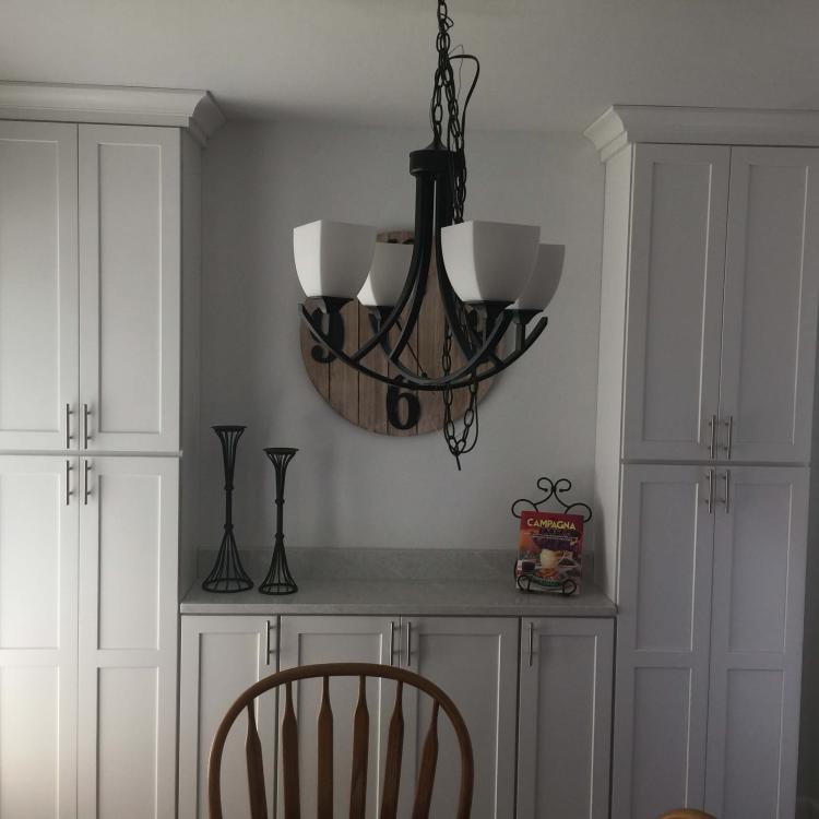 Kitchen remodel with new white cabinets and chandelier