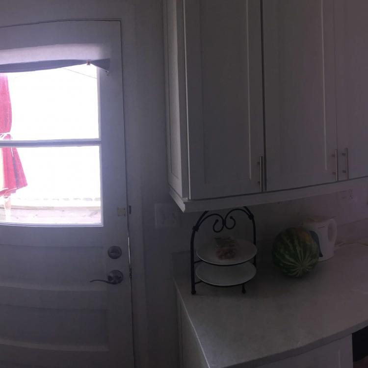 Kitchen remodel complete: white cabinets, quartz countertops, and stainless steel appliances