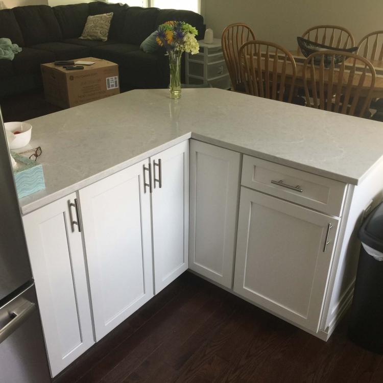 Kitchen countertop detail: white cabinets and quartz countertop.