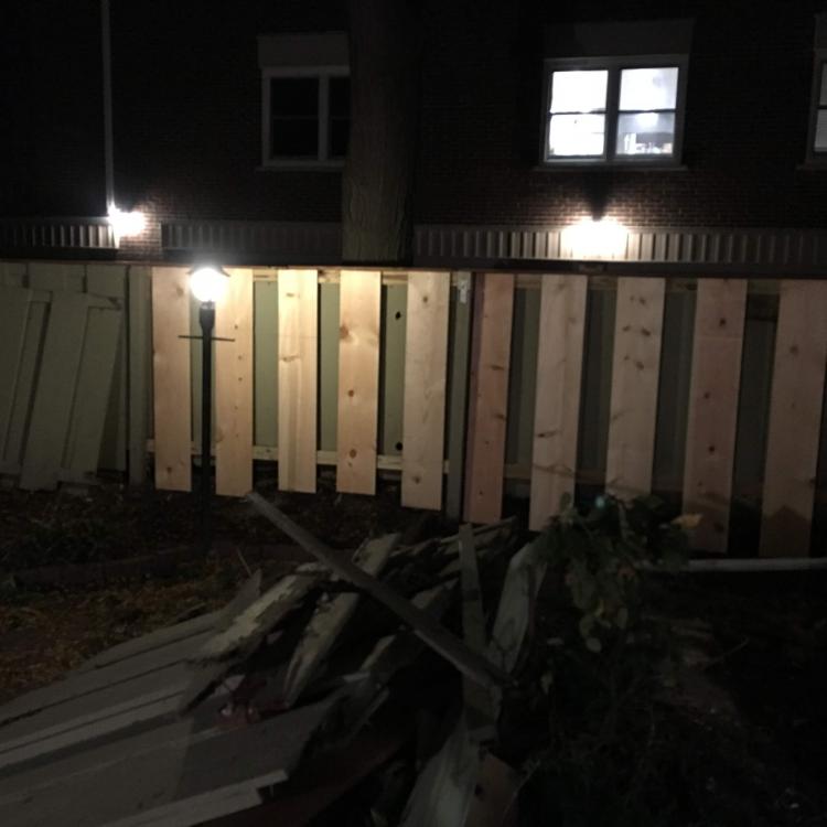 Completed backyard renovation with a new fence and outdoor lighting at other angle