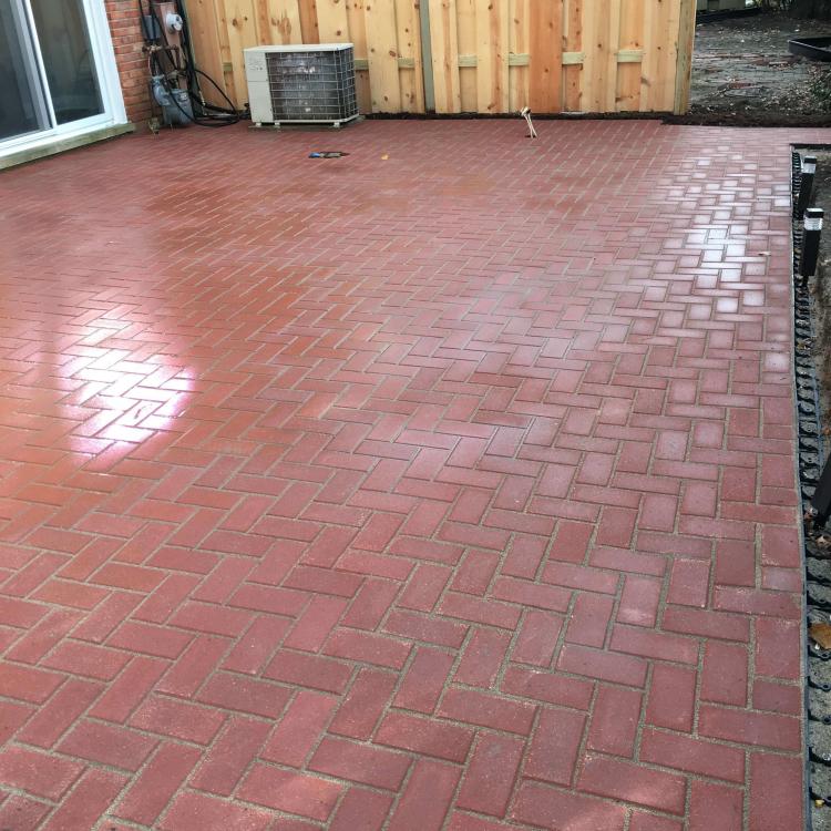 Completed renovation: backyard with a brick paver patio.