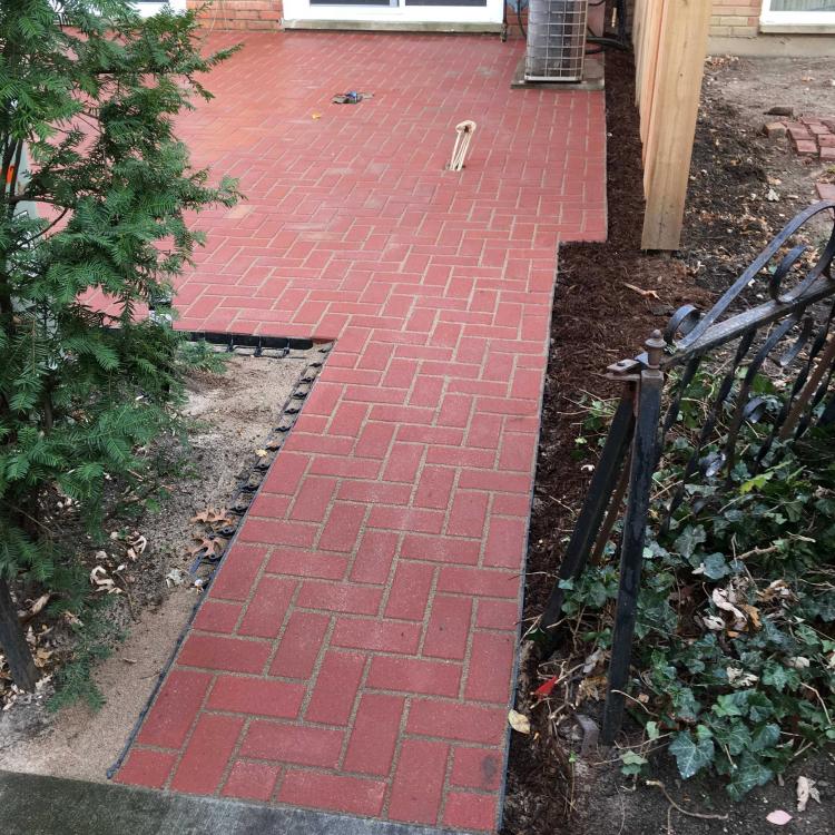 Completed renovation: backyard with a brick patio.