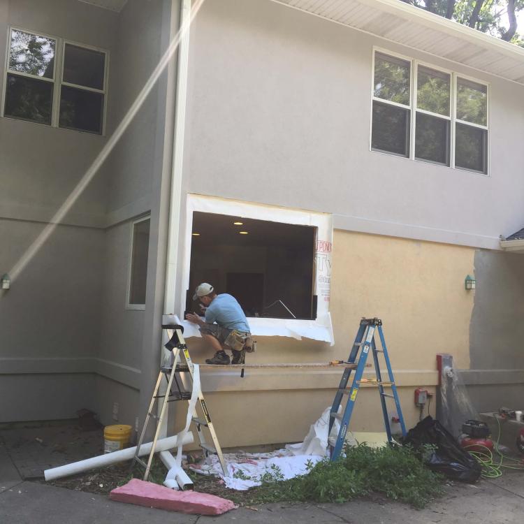 A home improvement project: a worker installing a new window