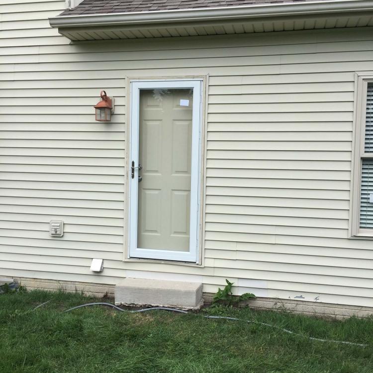 A completed storm door installation on a house