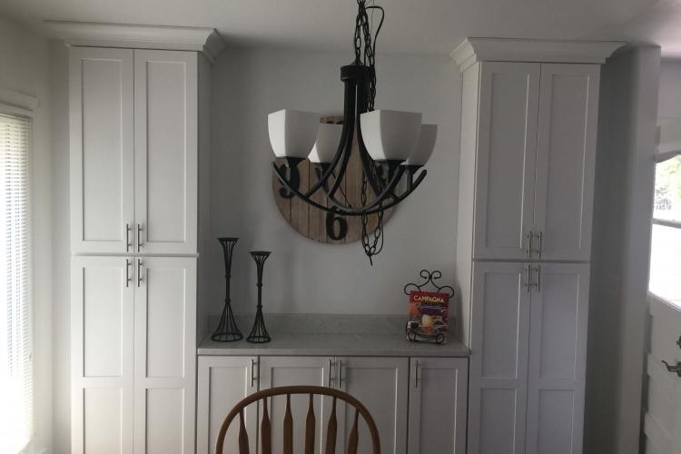 Kitchen remodel with new white cabinets and chandelier