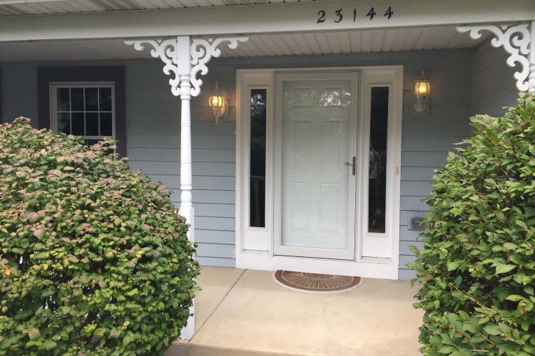 A house with a white front door and a newly installed storm door