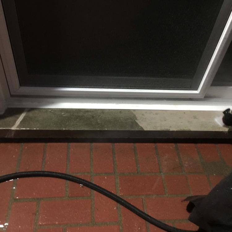 Power washing a patio to remove dirt and grime after home improvement works