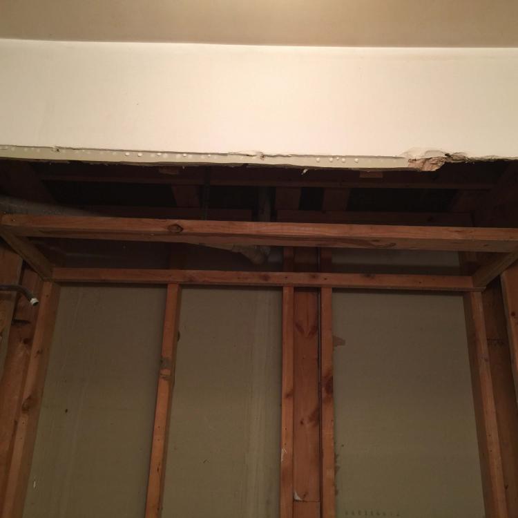 Bathroom renovation in progress: Ceiling demolition and framing.