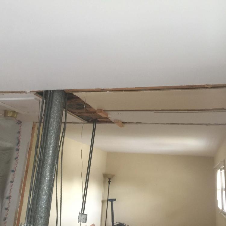 Mid-stage ceiling renovation, showcasing the potential for interior design transformations.