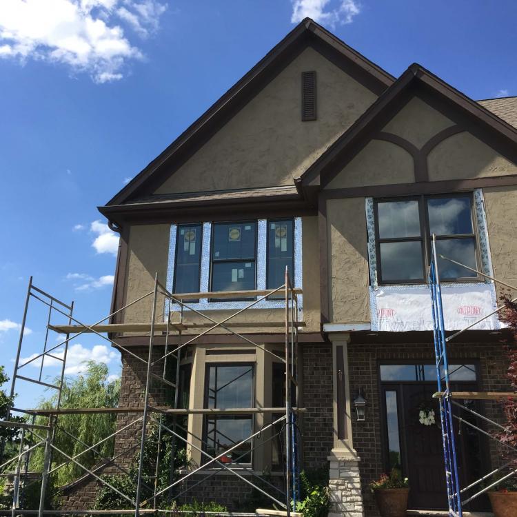 Window replacement in progress: House with scaffolding and new windows being installed