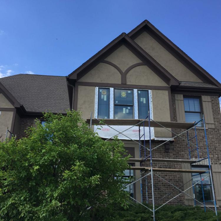 Home renovation project: House with scaffolding and new windows being installed