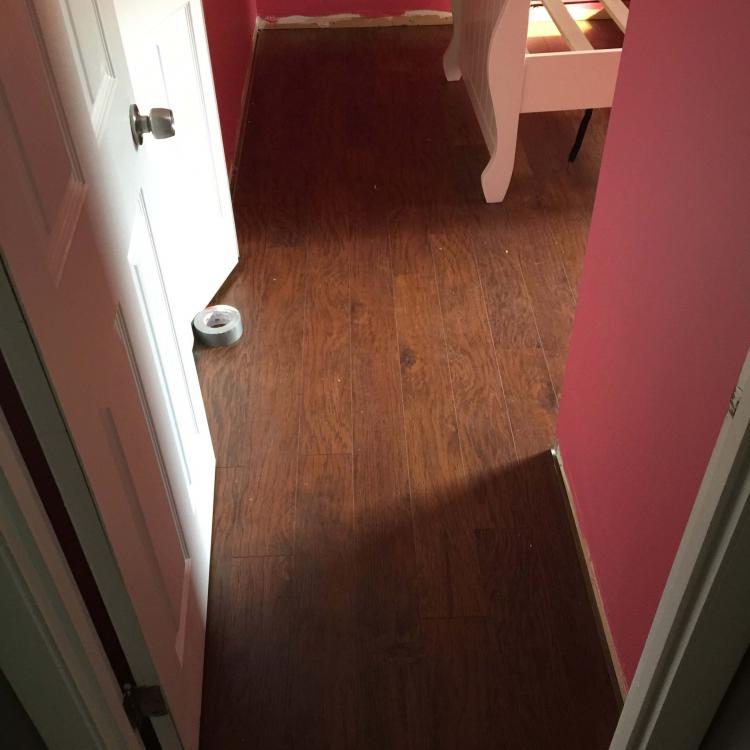 Laminate flooring installation in progress: New flooring being installed.