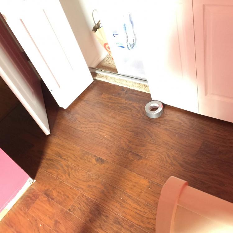 Laminate flooring installation in progress: Flooring being installed around a closet.