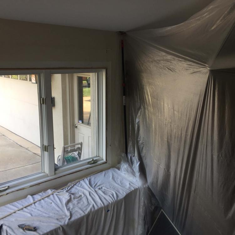 Interior view of a window replacement project, showing the old window being taken out