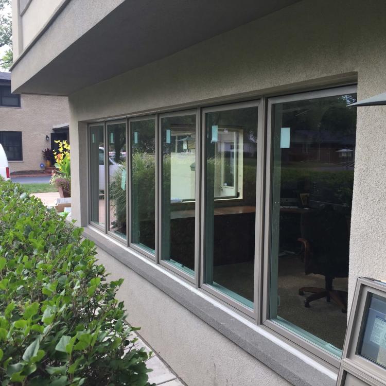 A modern window replacement project featuring a multi-pane sliding window.