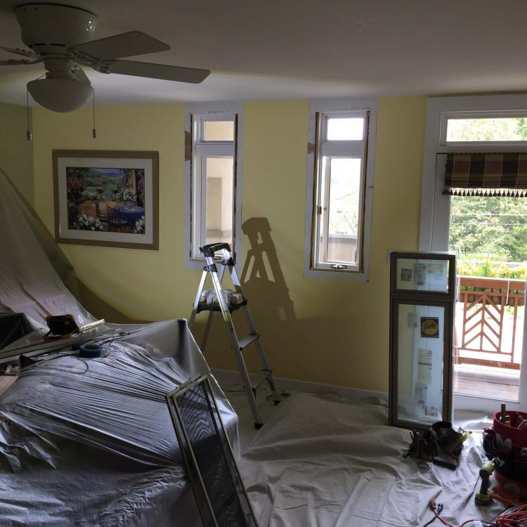 Interior view of a room with a window replacement in progress