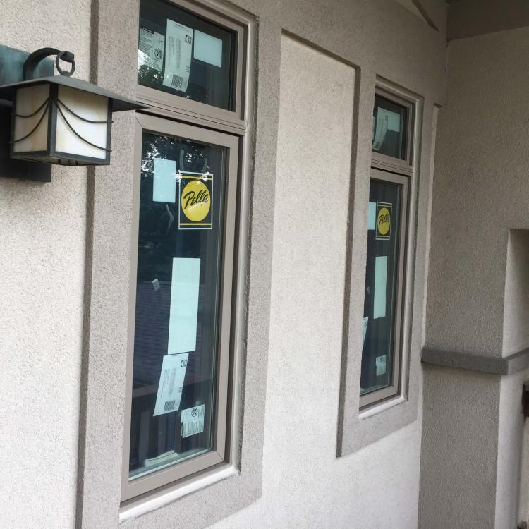 Exterior view of a house with newly installed, energy-efficient windows