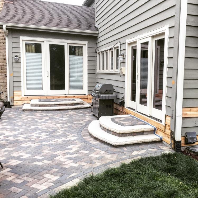 A house with sliding glass doors and repaired siding, awaiting finishing touches.